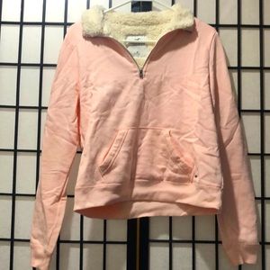 A baby pink sweater with sherpa